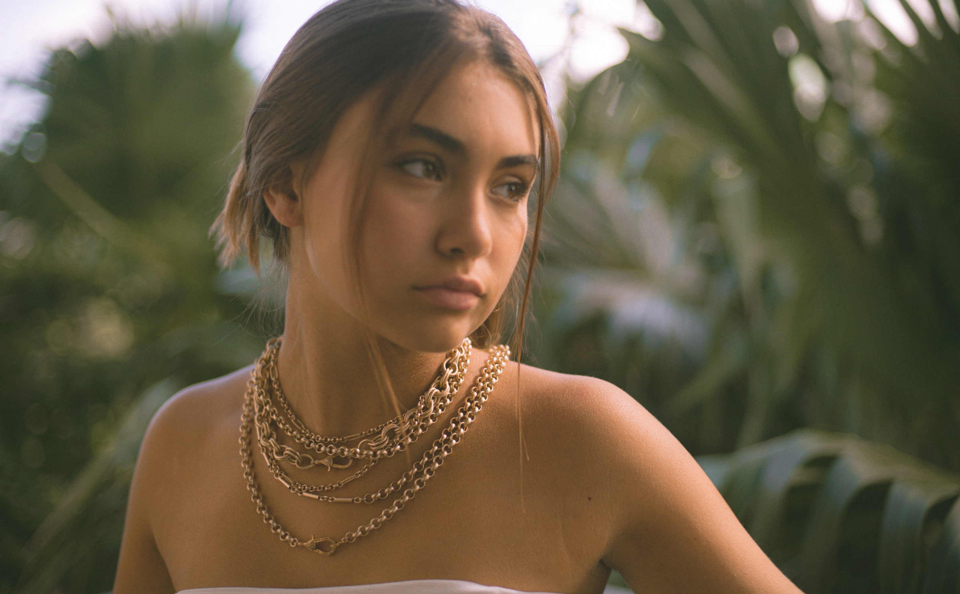 Model wearing layered chains